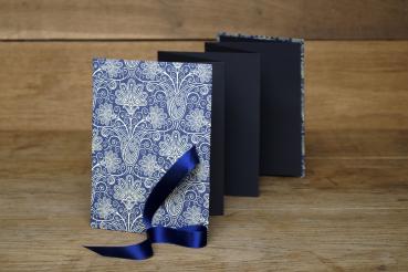 Mini photo book for 14 photos, blue and white, small graphic stars, yellow satin ribbon